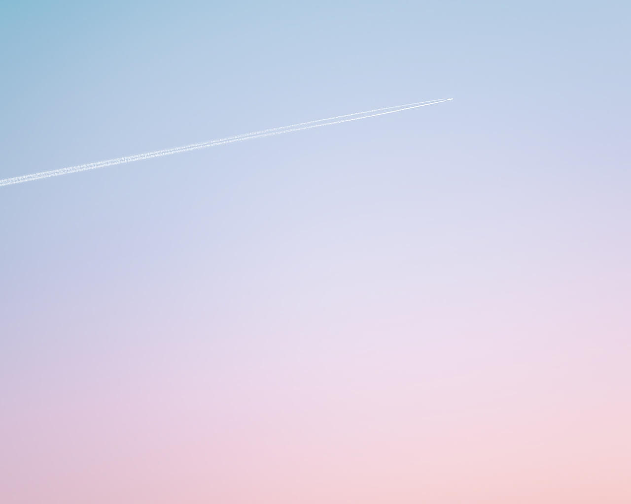 Bright morning sky with a jet leaving a vapour trail, representing 'Deploy', the final step in the 'Strategic Design' process used by Bendigo creative agency Creative Revolution for web design, logo design and branding, and digital marketing campaigns.